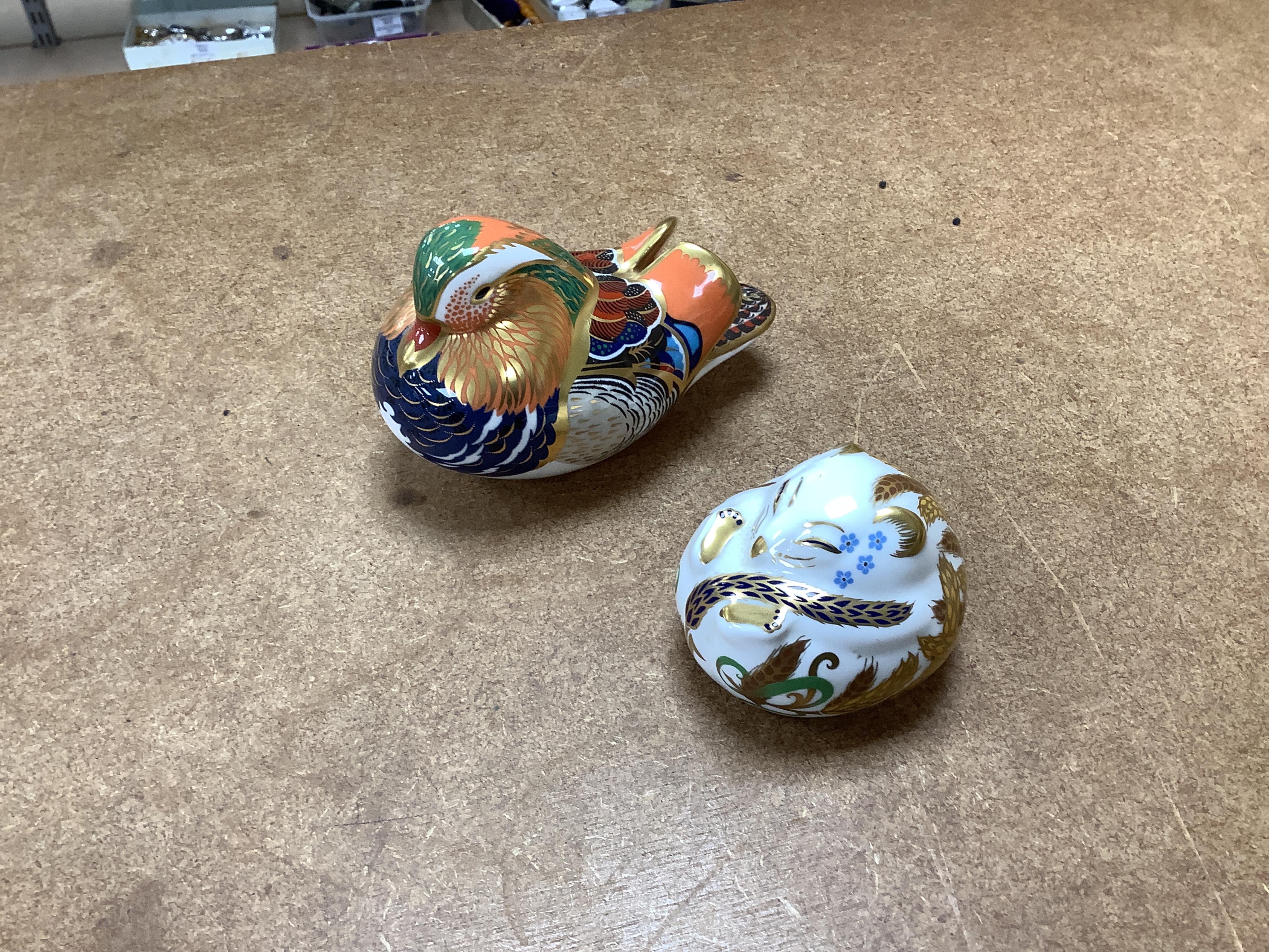 A collection of Royal Crown Derby Imari pattern paperweights, to include penguin and badger, together with three Doulton flambé animals, largest 19cm wide